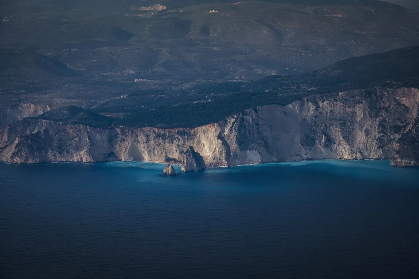 Aerial view of dramatic cliffs and azure waters along the northern Zakynthos coastline